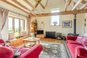 a living room with two red couches and a table at 2 Bed in Dorchester oc-dc075 in Charminster