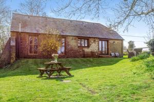 a brick house with a picnic table in front of it at 2 Bed in Dorchester oc-dc075 in Charminster