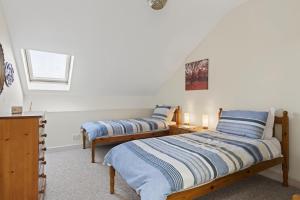 a bedroom with two beds and a window at 2 Bed in Beaminster oc-63047 in Broadwindsor