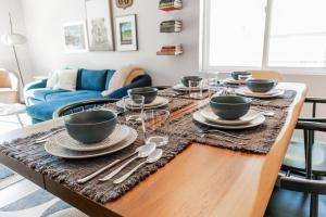 a dining room table with plates and silverware on it at The Pine House in Flagstaff