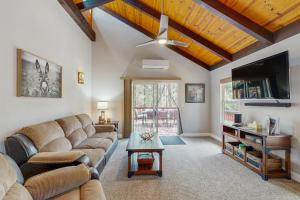 a living room with a couch and a flat screen tv at Wild West Wonder in Pinetop-Lakeside