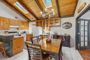 a kitchen with wooden cabinets and a wooden table at Wild West Wonder in Pinetop-Lakeside +20 photos