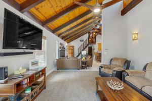 a living room with a large flat screen tv at Wild West Wonder in Pinetop-Lakeside