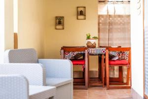 a table with two chairs and a table with a plant at Il Posto Giusto in Costa Rei