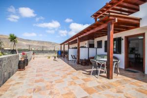 a patio of a house with a table and chairs at Finca Villanueva in Mala
