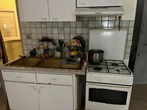 a kitchen with a sink and a stove at Cocon de Audrey in Graulhet