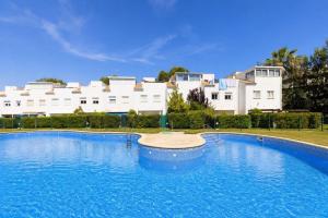 a large swimming pool in front of a building at NATURE PLUS Family House in Salou