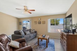 a living room with a couch and a tv at Peaceful Valley in Tucson