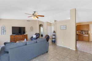 a living room with a couch and a flat screen tv at Peaceful Valley in Tucson