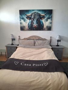 a bed with a picture of a bull on the wall at Casa Piszi in Torrevieja