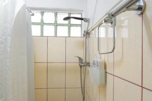 a shower with a shower head in a bathroom at Lagos Central Hostel in Lagos +76 photos