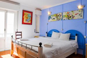 a blue bedroom with a bed and a blue wall at Lagos Central Hostel in Lagos