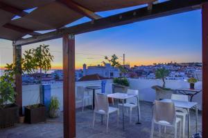 a balcony with tables and chairs and a view of the city at Lagos Central Hostel in Lagos