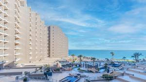 a large hotel with a pool and a resort at Las Palomas Beach & Golf Resort - One Bedroom Condos in Puerto Peñasco