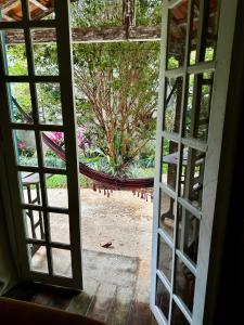 an open window with a view of a garden at Cantinho Almeida in Tiradentes
