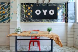 a table in a store with a sign on the wall at Hotel O S.R GRAND HOTEL & RESTAURANT in Kānpur