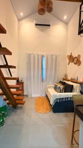 a living room with a bed and a window at Loft Brisa de Búzios in Búzios