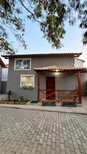 a house with a brick driveway in front of it at Loft Brisa de Búzios in Búzios