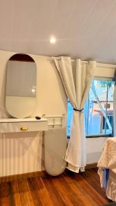 a bedroom with a white curtain and a window at Loft Brisa de Búzios in Búzios +12 photos