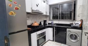 a kitchen with a sink and a dishwasher at Appart Ennakhil 4 avenue mohamed 6 in El Jadida