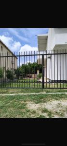 a black fence in front of a building at Talic Apartmani in Sutomore