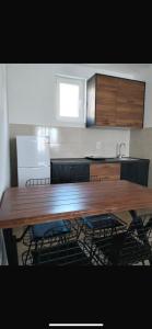 a large wooden table with chairs in a kitchen at Talic Apartmani in Sutomore