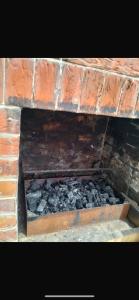 a brick oven with a pile of rocks in it at Talic Apartmani in Sutomore