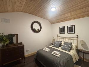 a bedroom with a bed with two towels on it at Mag Byrne's Cottage in Sandy Ford
