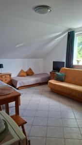 a living room with two beds and a couch at Willa Puchatek in Gąski