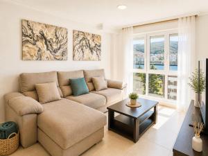 a living room with a couch and a table at Apartamento vistas al mar in Viveiro
