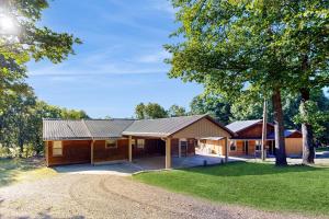 a cabin with a tree and a dirt road at Sprawling Eufaula Lake Sanctuary w/ Dock! in Texanna