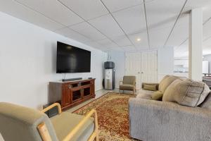a living room with a couch and a flat screen tv at Sprawling Eufaula Lake Sanctuary w/ Dock! in Texanna