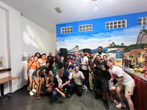 a group of people posing for a picture in a room at Arcos Da Lapa Hostel in Rio de Janeiro