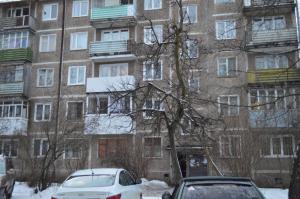 an apartment building with cars parked in front of it at Apartaments at Shevchenko 66 in Smolensk