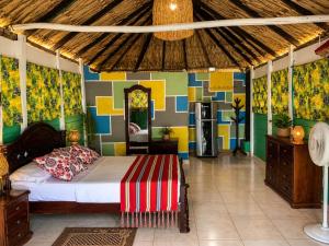 a bedroom with a bed and a colorful wall at Antara del Mar in San Bernardo del Viento