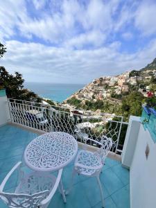 a balcony with two chairs and a table and a view at Santiago vacation home in Positano in Positano