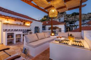 a patio with a couch and a table at Manu's House - Refined Design, Effortless Space in Skopelos Town
