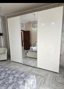 a mirror in a room with a bed and a bedroom at Alloggio Acqui in Acqui Terme