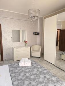 a bedroom with a bed and a dresser and a mirror at Alloggio Acqui in Acqui Terme