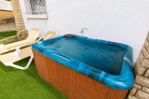 a large hot tub sitting next to two chairs at Casa CODOLAR in Salou