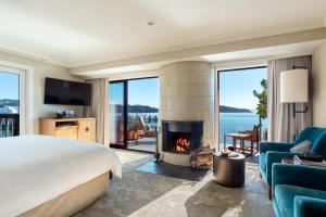 a bedroom with a king bed and a fireplace at The Inn Above Tide in Sausalito