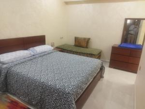 a bedroom with a bed and a chair in it at apartamente á fes in Fez