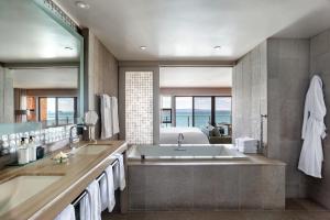 a bathroom with a large tub and a bedroom at The Inn Above Tide in Sausalito +87 photos