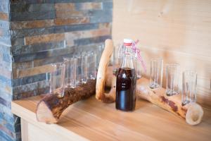 a table with glasses and a bottle of sauce at Steineralm in Schwersberg +45 photos