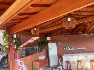 a restaurant with wooden ceilings and a bar with stools at Cantinho do Rosário in Diamantina