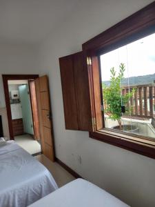 a room with a window and a bed and a view at Cantinho do Rosário in Diamantina