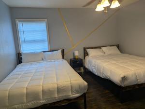 a bedroom with two beds and a window at Fresh start small breakfast cook and serve your self in Lubbock