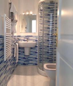 a bathroom with a sink and a toilet and a mirror at Santiago vacation home in Positano in Positano +51 photos