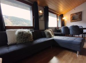 a living room with a couch and some windows at AC Apartaments Sol Tarter in El Tarter
