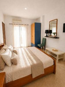 a bedroom with a large bed and a mirror at Flogita 5 Seaside Apartments - 150m from Beach, Ideal for Families & Groups in Flogita